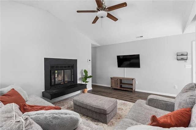 living room with vaulted ceiling, wood finished floors, ceiling fan, baseboards, and visible vents