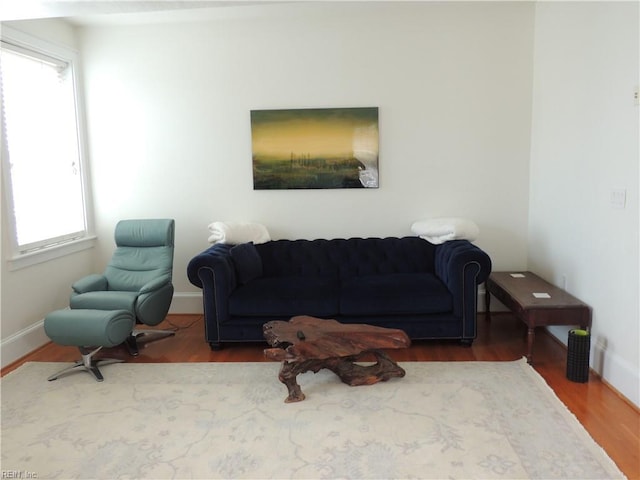 living area featuring wood finished floors and baseboards