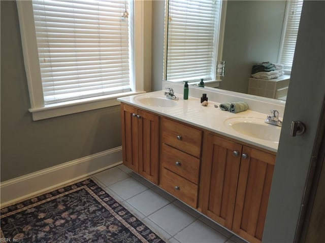 bathroom with double vanity, tile patterned floors, and a sink