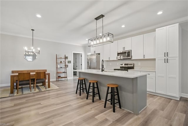 429 Maryland Ave, Norfolk, VA 23508 - kitchen featuring a kitchen island with sink, a chandelier, stainless steel appliances, a kitchen bar, and a sink
