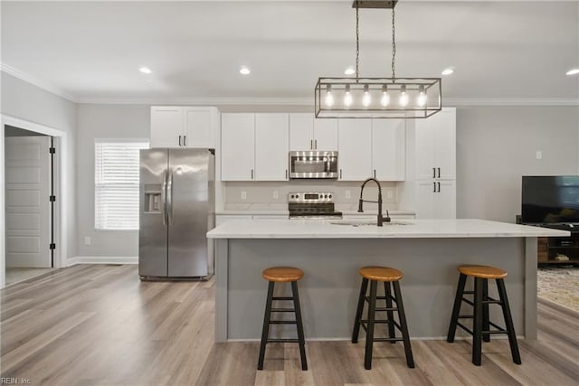 429 Maryland Ave, Norfolk, VA 23508 - kitchen featuring appliances with stainless steel finishes, light wood finished floors, a sink, white cabinetry, and crown molding