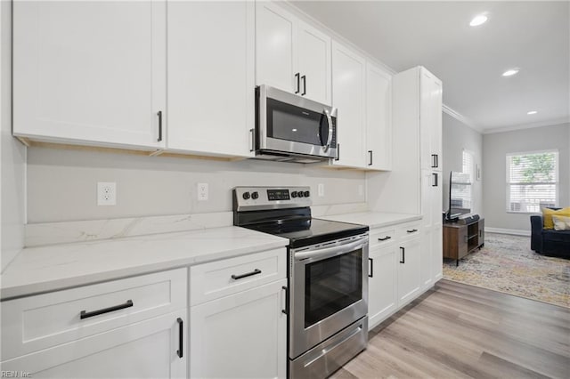 429 Maryland Ave, Norfolk, VA 23508 - kitchen featuring appliances with stainless steel finishes, light wood-type flooring, ornamental molding, and white cabinets