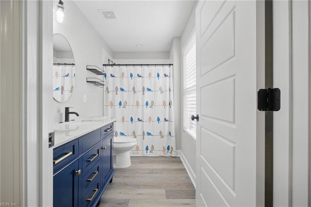 429 Maryland Ave, Norfolk, VA 23508 - bathroom with a sink, double vanity, visible vents, toilet, and wood finished floors