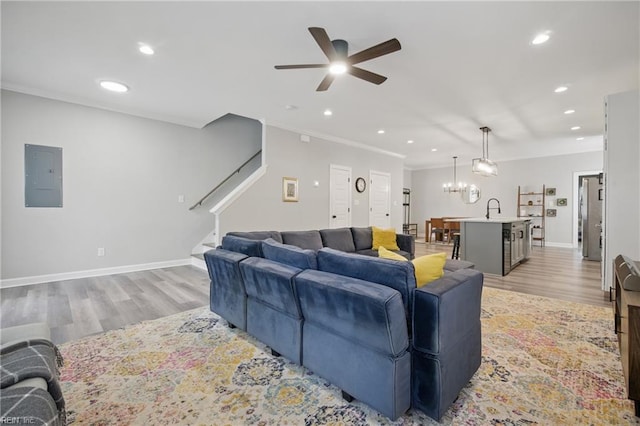 429 Maryland Ave, Norfolk, VA 23508 - living room featuring stairway, ceiling fan with notable chandelier, electric panel, and light wood-style flooring