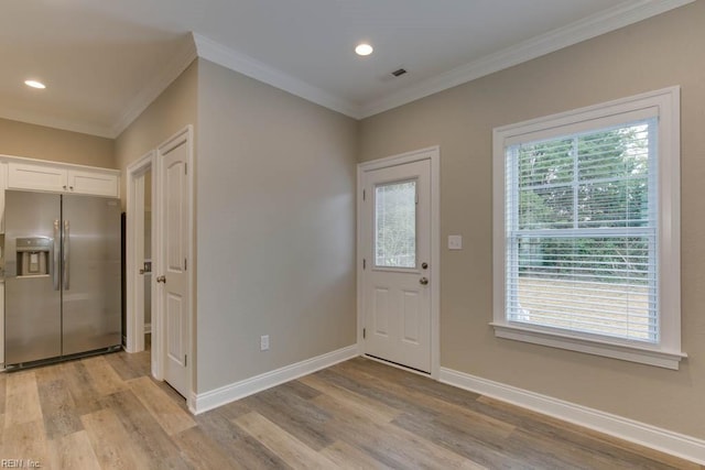 entryway with recessed lighting, light wood-style floors, and crown molding