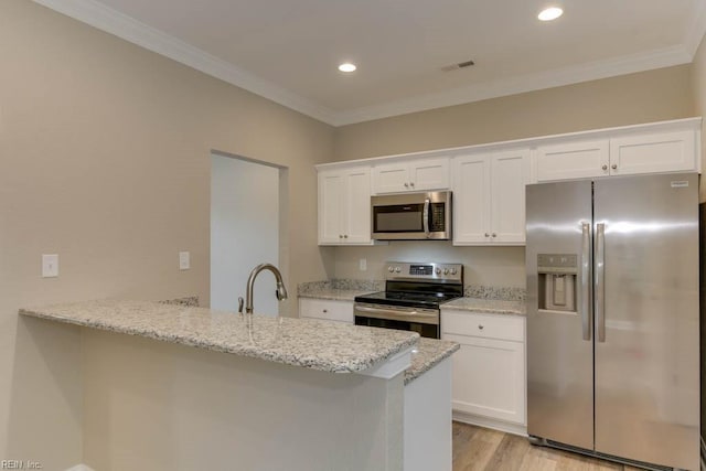 kitchen featuring white cabinets, ornamental molding, visible vents, and appliances with stainless steel finishes