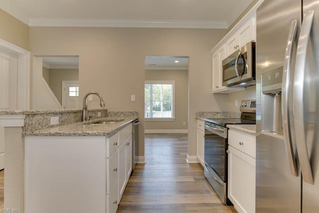kitchen featuring a sink, white cabinetry, light wood-style floors, crown molding, and appliances with stainless steel finishes