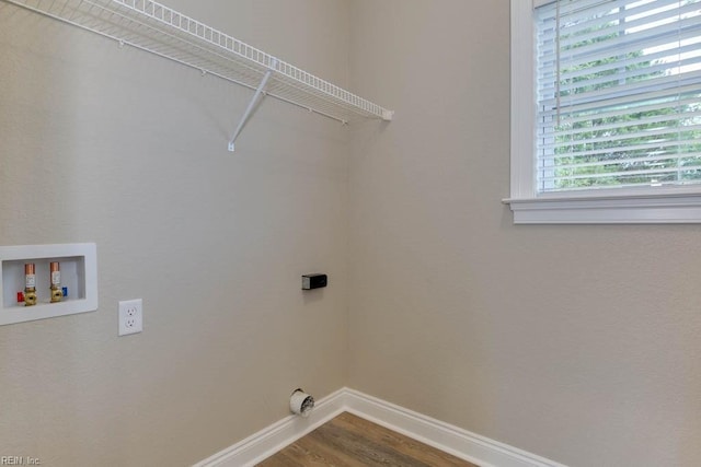 laundry room featuring washer hookup, wood finished floors, baseboards, and laundry area