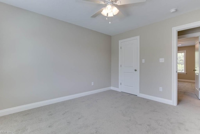 unfurnished bedroom featuring carpet floors, a ceiling fan, and baseboards