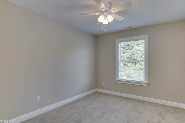 unfurnished room featuring visible vents, baseboards, ceiling fan, and light colored carpet