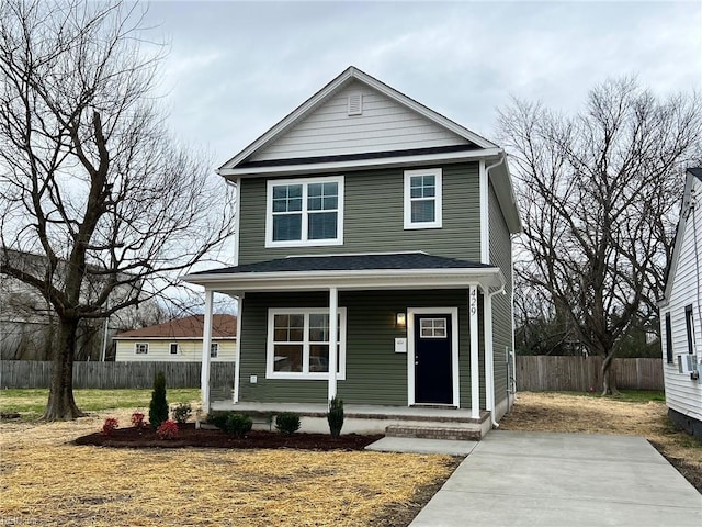 view of front of home with covered porch and fence