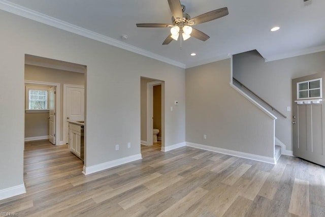 unfurnished living room featuring baseboards, light wood-style floors, a ceiling fan, stairs, and ornamental molding
