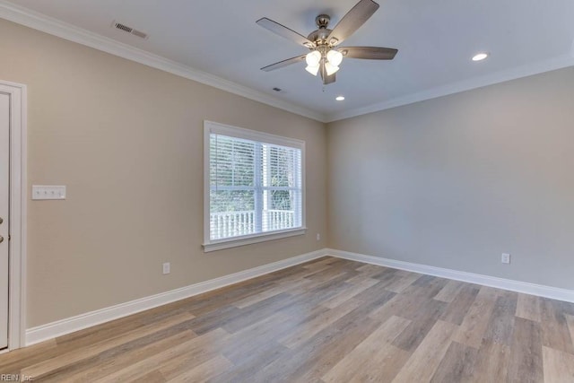 unfurnished room with ornamental molding, baseboards, a ceiling fan, and light wood-style floors