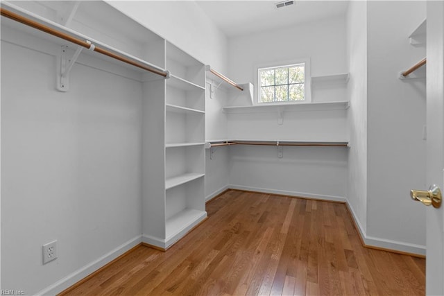 spacious closet with visible vents and wood finished floors