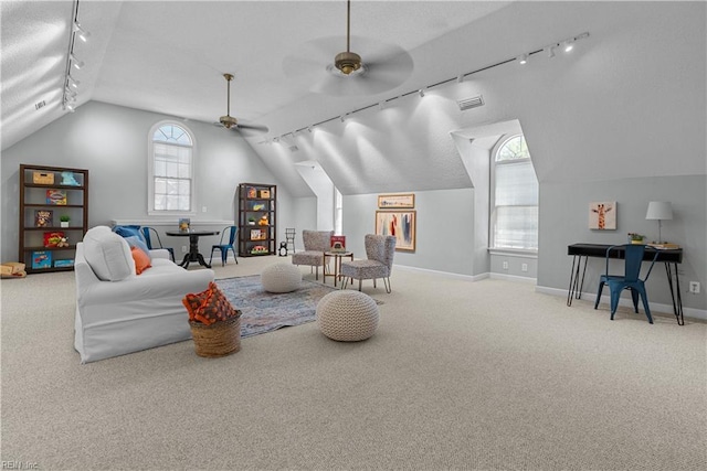 interior space featuring track lighting, visible vents, baseboards, ceiling fan, and vaulted ceiling