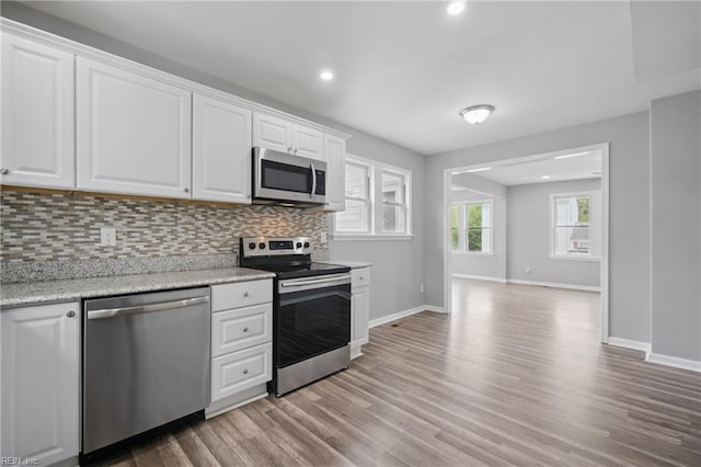 237 Pochin Pl, Hampton, VA 23661 - kitchen featuring light wood finished floors, stainless steel appliances, baseboards, and backsplash