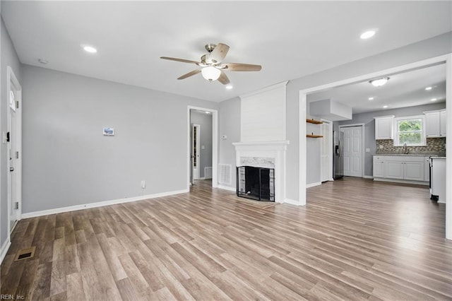237 Pochin Pl, Hampton, VA 23661 - unfurnished living room featuring light wood-style flooring, a ceiling fan, and baseboards