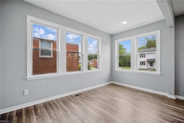 237 Pochin Pl, Hampton, VA 23661 - spare room featuring wood finished floors, a healthy amount of sunlight, baseboards, and visible vents