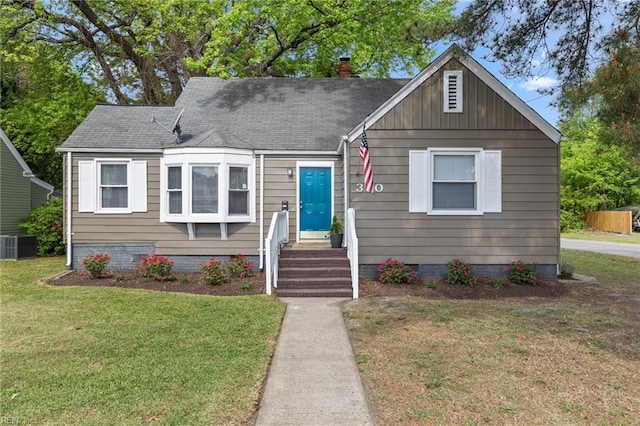 bungalow-style house featuring a chimney, a front lawn, central air condition unit, crawl space, and roof with shingles
