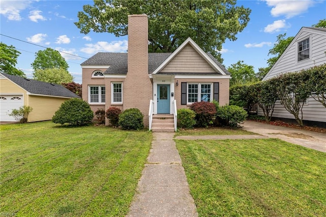 212 Cherokee Rd, Hampton, VA 23661 - bungalow-style home featuring a chimney, brick siding, and a front yard