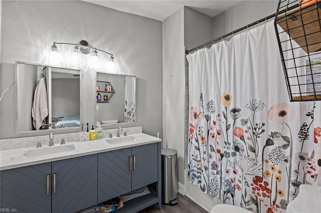 212 Cherokee Rd, Hampton, VA 23661 - ensuite bathroom featuring double vanity, toilet, wood finished floors, and a sink