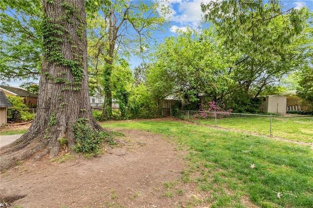 212 Cherokee Rd, Hampton, VA 23661 - view of yard featuring fence, a storage unit, and an outbuilding