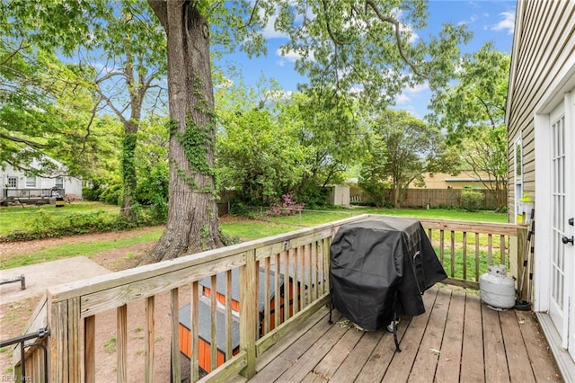 212 Cherokee Rd, Hampton, VA 23661 - wooden deck with a storage unit, a fenced backyard, a lawn, an outdoor structure, and area for grilling