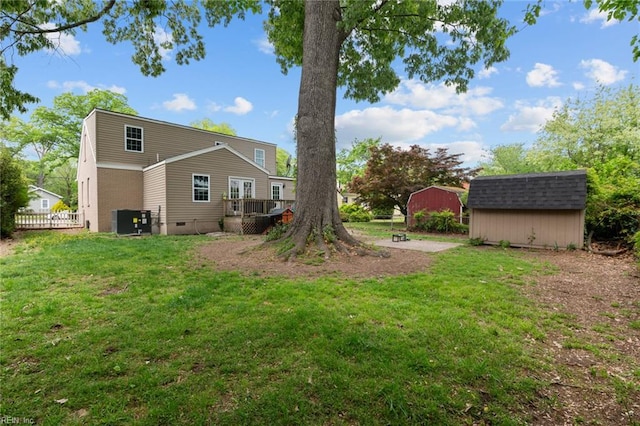212 Cherokee Rd, Hampton, VA 23661 - back of property featuring a storage shed, central air condition unit, a lawn, a deck, and an outbuilding