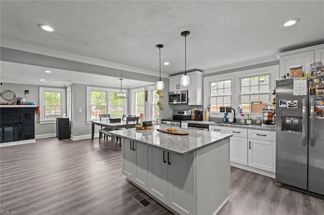 212 Cherokee Rd, Hampton, VA 23661 - kitchen with crown molding, appliances with stainless steel finishes, a sink, and a kitchen island