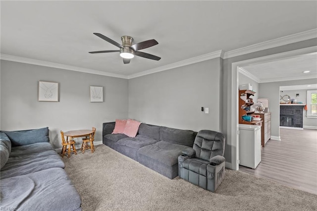 212 Cherokee Rd, Hampton, VA 23661 - living room with crown molding, ceiling fan, carpet floors, baseboards, and a brick fireplace