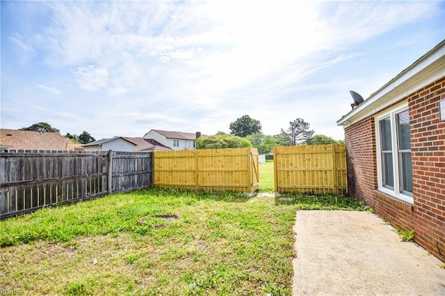 view of yard with a patio and a fenced backyard