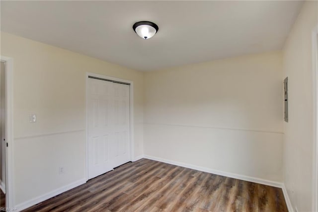 empty room featuring baseboards and wood finished floors