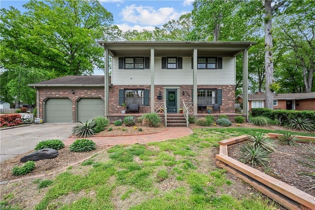 view of front of property featuring an attached garage, a porch, brick siding, and concrete driveway