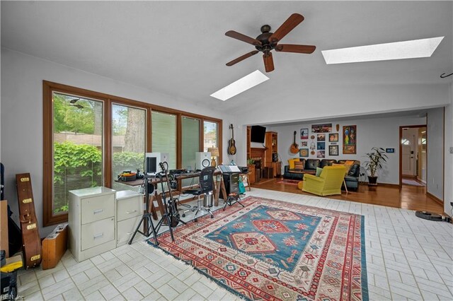 home office featuring a ceiling fan and lofted ceiling with skylight