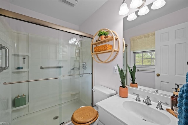 bathroom featuring a shower stall, vanity, toilet, a notable chandelier, and visible vents