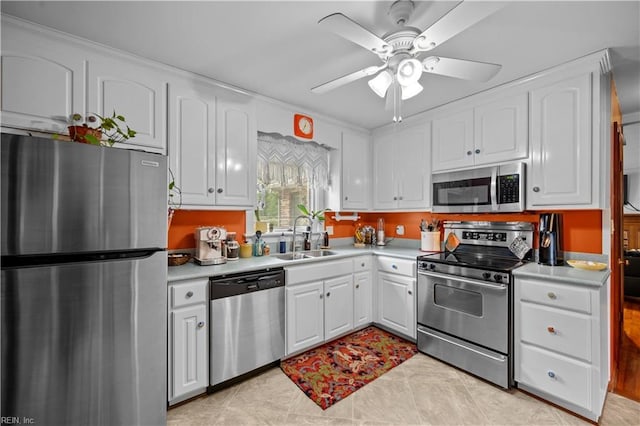 kitchen featuring light countertops, white cabinetry, stainless steel appliances, and a sink