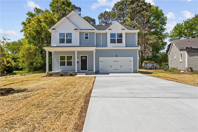6471 Swan Arch, Norfolk, VA 23513 - view of front facade with concrete driveway, board and batten siding, covered porch, a front lawn, and a garage