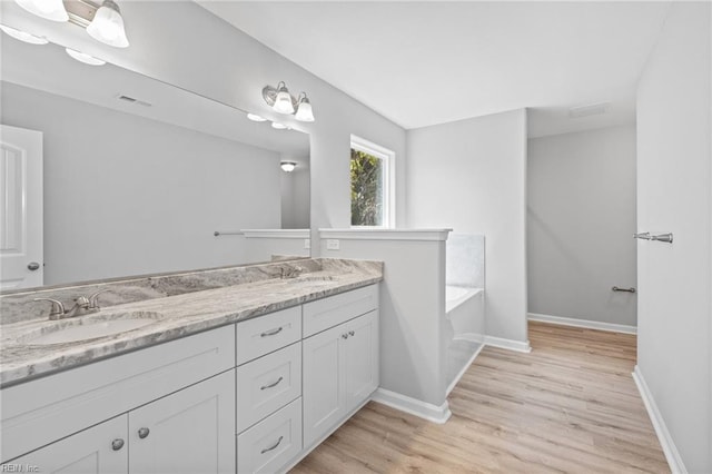 6471 Swan Arch, Norfolk, VA 23513 - full bath featuring a sink, double vanity, baseboards, a garden tub, and wood finished floors