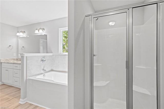 6471 Swan Arch, Norfolk, VA 23513 - bathroom featuring a garden tub, a stall shower, wood finished floors, and vanity
