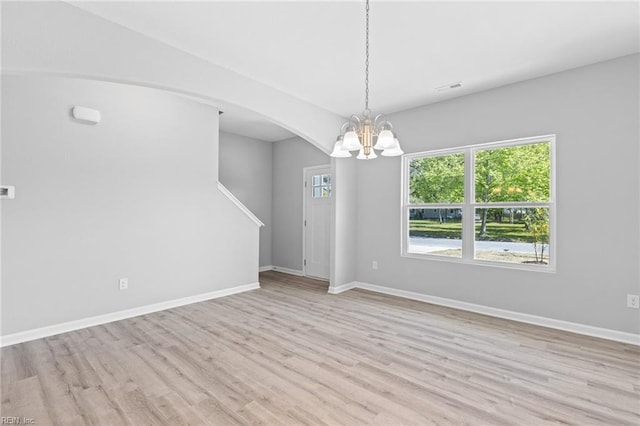 6471 Swan Arch, Norfolk, VA 23513 - spare room with light wood finished floors, a chandelier, visible vents, baseboards, and arched walkways