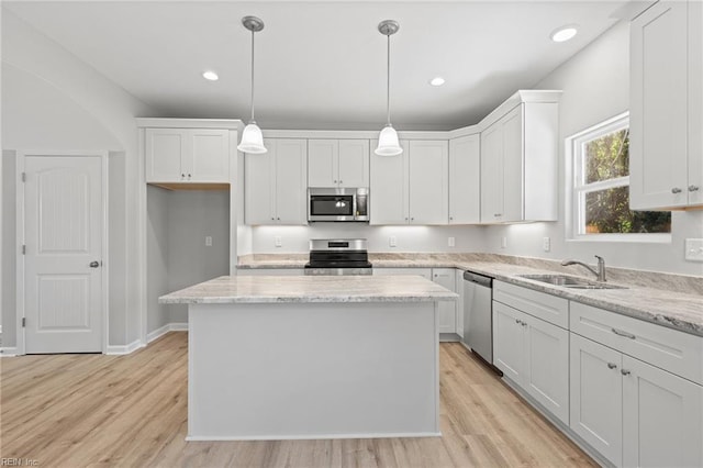 6471 Swan Arch, Norfolk, VA 23513 - kitchen with a sink, white cabinetry, light wood-style flooring, a kitchen island, and appliances with stainless steel finishes
