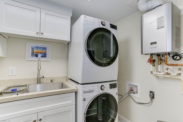 laundry room with tankless water heater, cabinet space, stacked washer / dryer, and a sink
