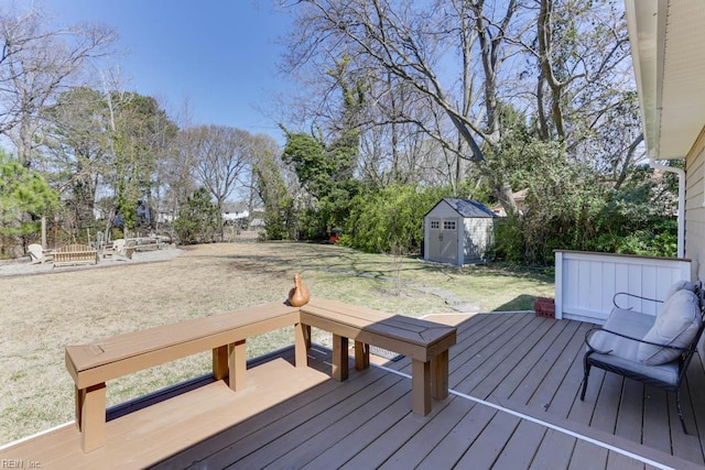 wooden deck with an outdoor structure, a yard, and a storage shed