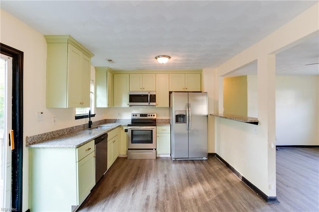 20 Mac Alva Dr, Hampton, VA 23669 - kitchen with stainless steel appliances, cream cabinetry, dark wood-type flooring, and a sink
