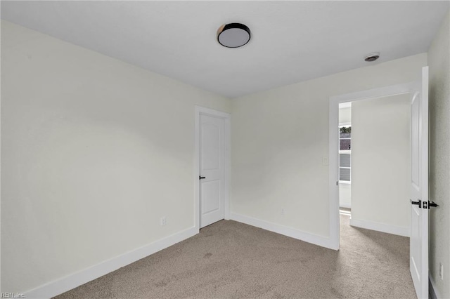 unfurnished bedroom featuring carpet flooring and baseboards