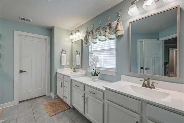 full bathroom featuring tile patterned floors, baseboards, visible vents, and vanity