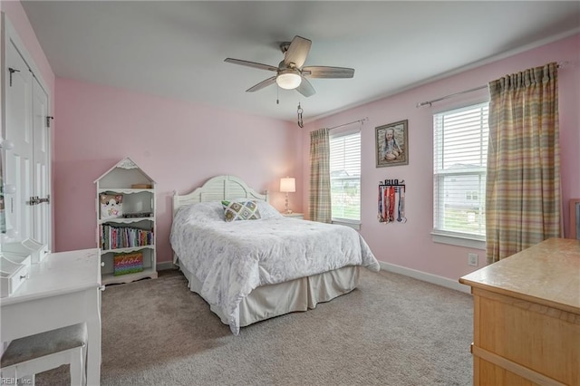 bedroom with light carpet, a ceiling fan, and baseboards