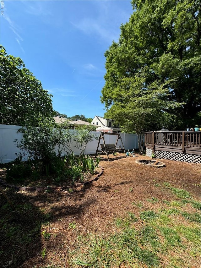 521 N Shore Rd, Norfolk, VA 23505 - view of yard with a deck, a fenced backyard, and a playground