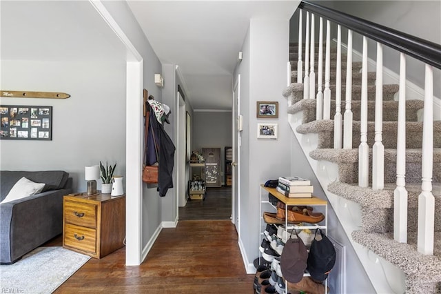 interior space with wood finished floors, baseboards, and stairway