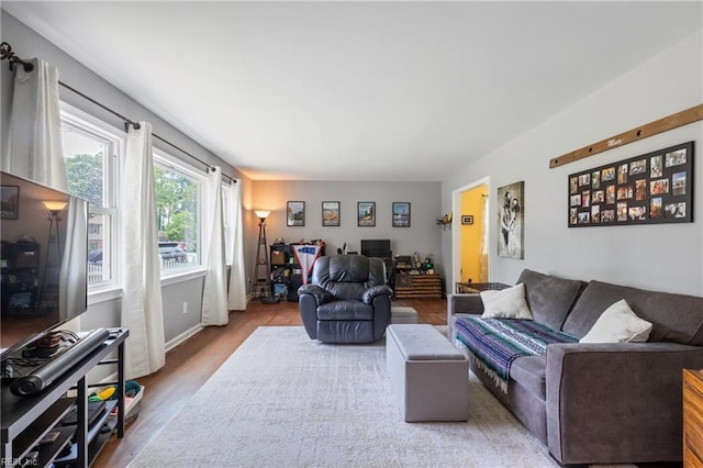 living area featuring baseboards and wood finished floors